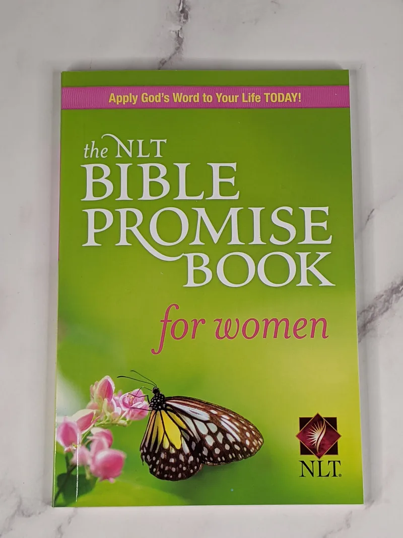The NLT Bible Promise Book for Women, a paperback book with a green cover.