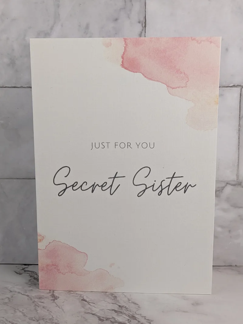 "Just for You Secret Sister" greeting card with a pink and white watercolor design.