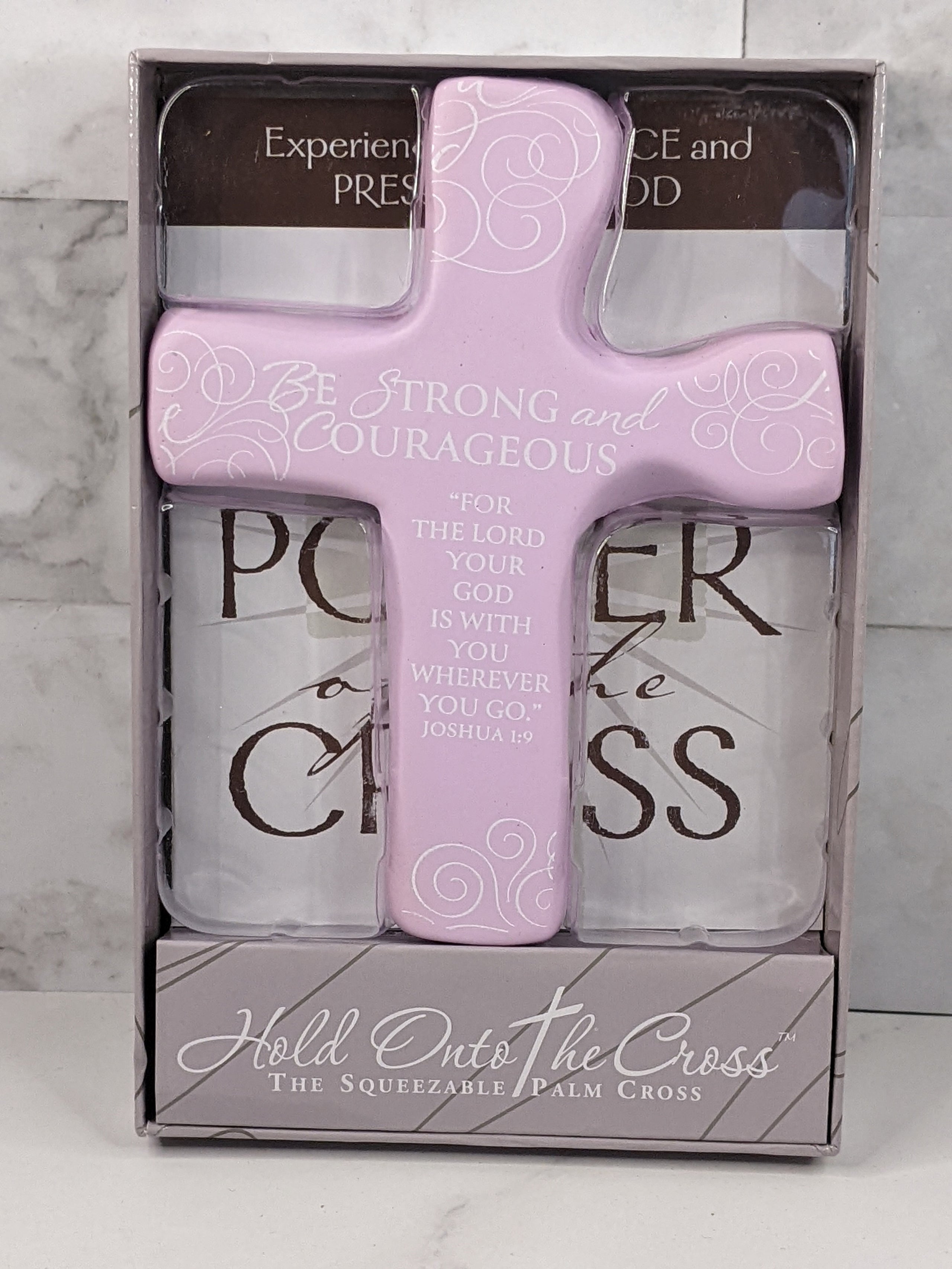 A small gift book, The Power of the Cross, that comes with a squeezable light purple cross.