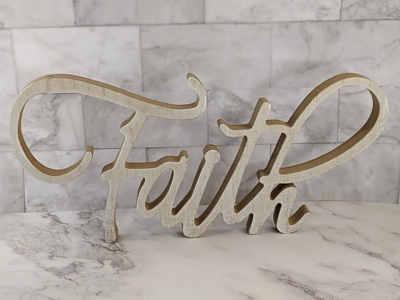 A wood-like cutout word with the message, "Faith."
