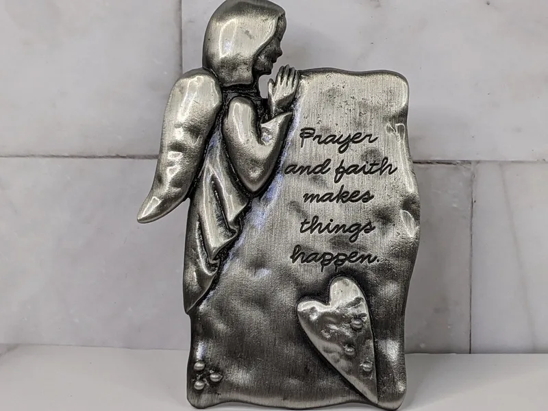 "Prayer and faith makes things happen." A pewter angel tabletop plaque with a reminder to pray with faith!