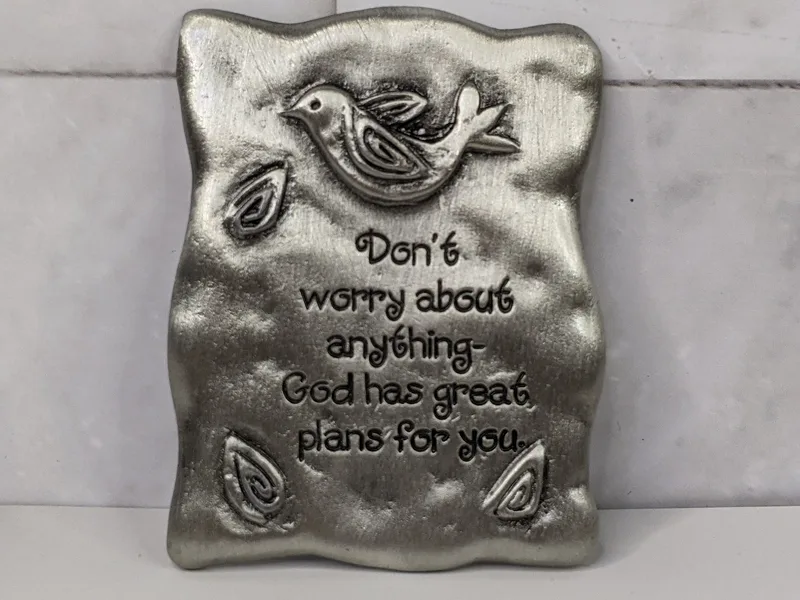 "Don't worry about anything - God has great plans for you." A pewter magnet with a bird design.