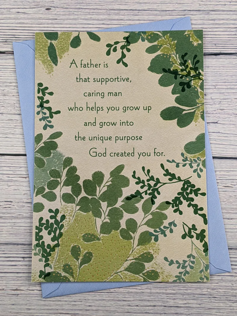 A Dayspring greeting card for Father's Day with a religious message and a tan cover with images of green leaves.