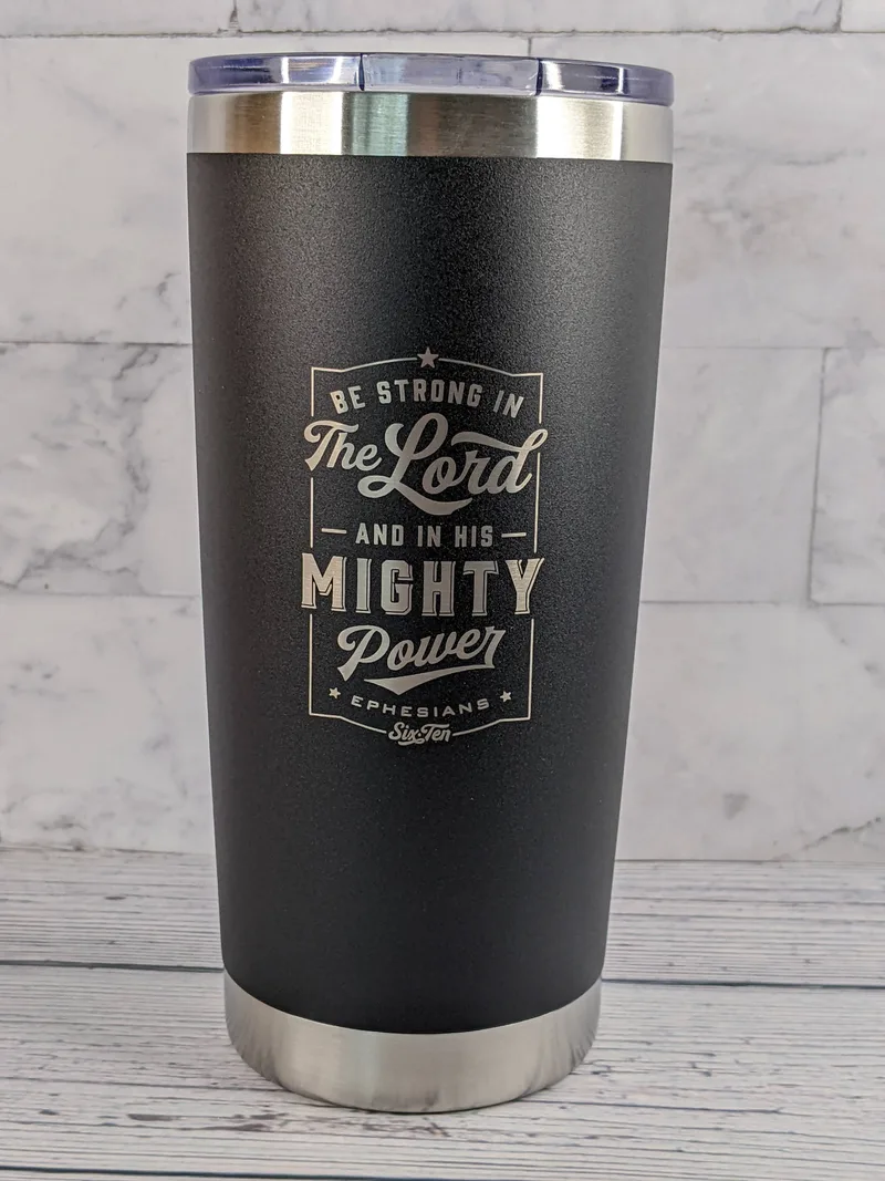 A black travel coffee mug tumbler made of stainless-steel, featuring a religious Scripture: Be strong in the Lord.