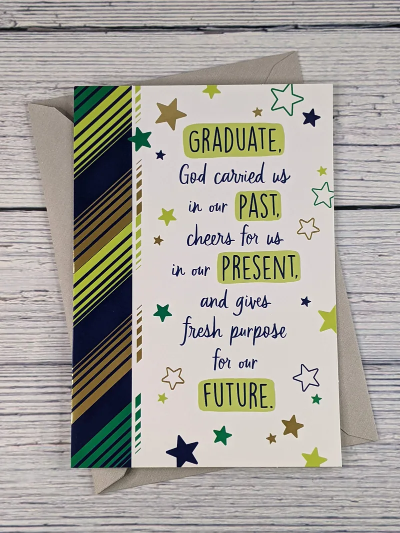 A religious graduation card with a pattern of stars and green, blue, and gold stripes.