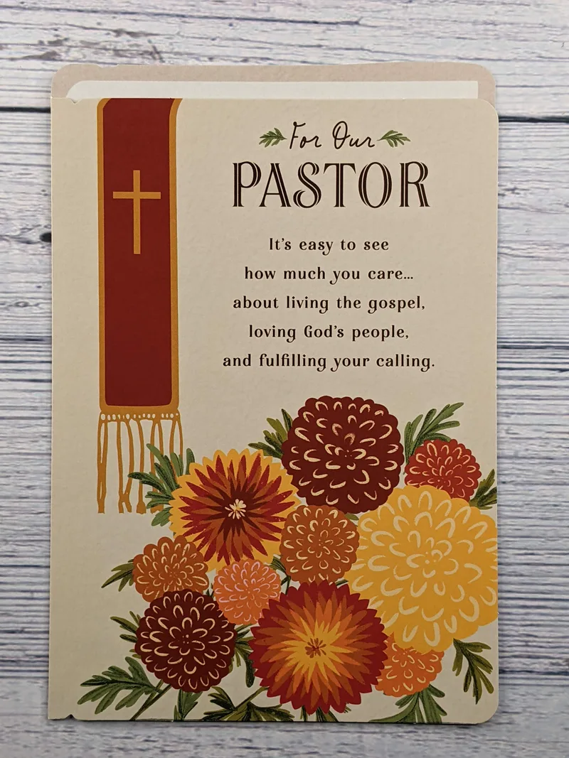 A greeting card with an image of a pastor's stole liturgical vestment and yellow and orange flowers.