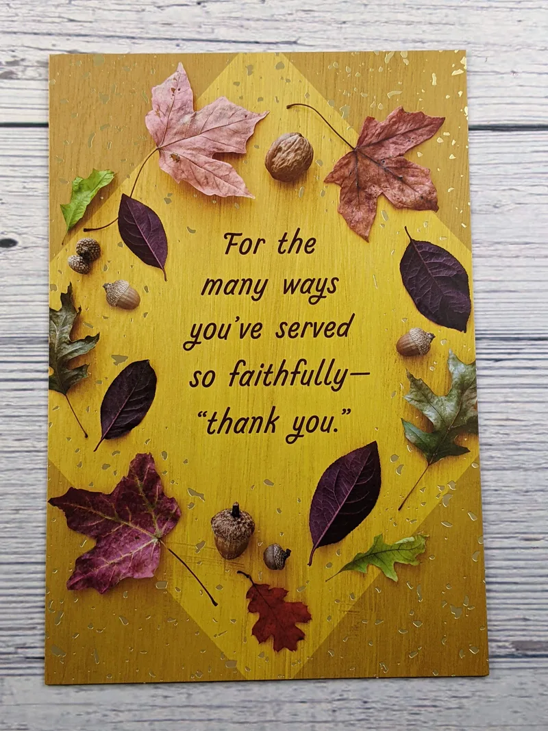 A pastor appreciation card with a gold background and images of colorful leaves.