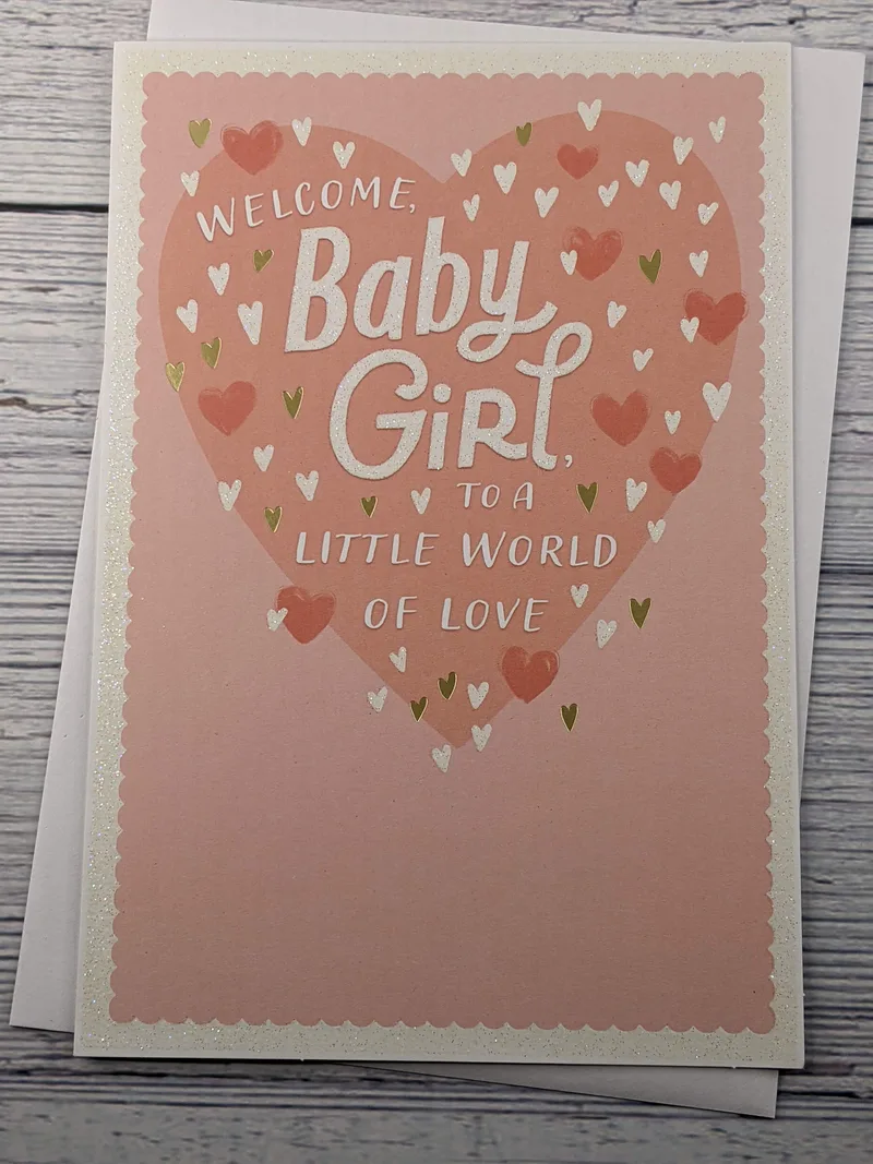 A pink greeting card to welcome a baby girl to the world, with images of hearts.