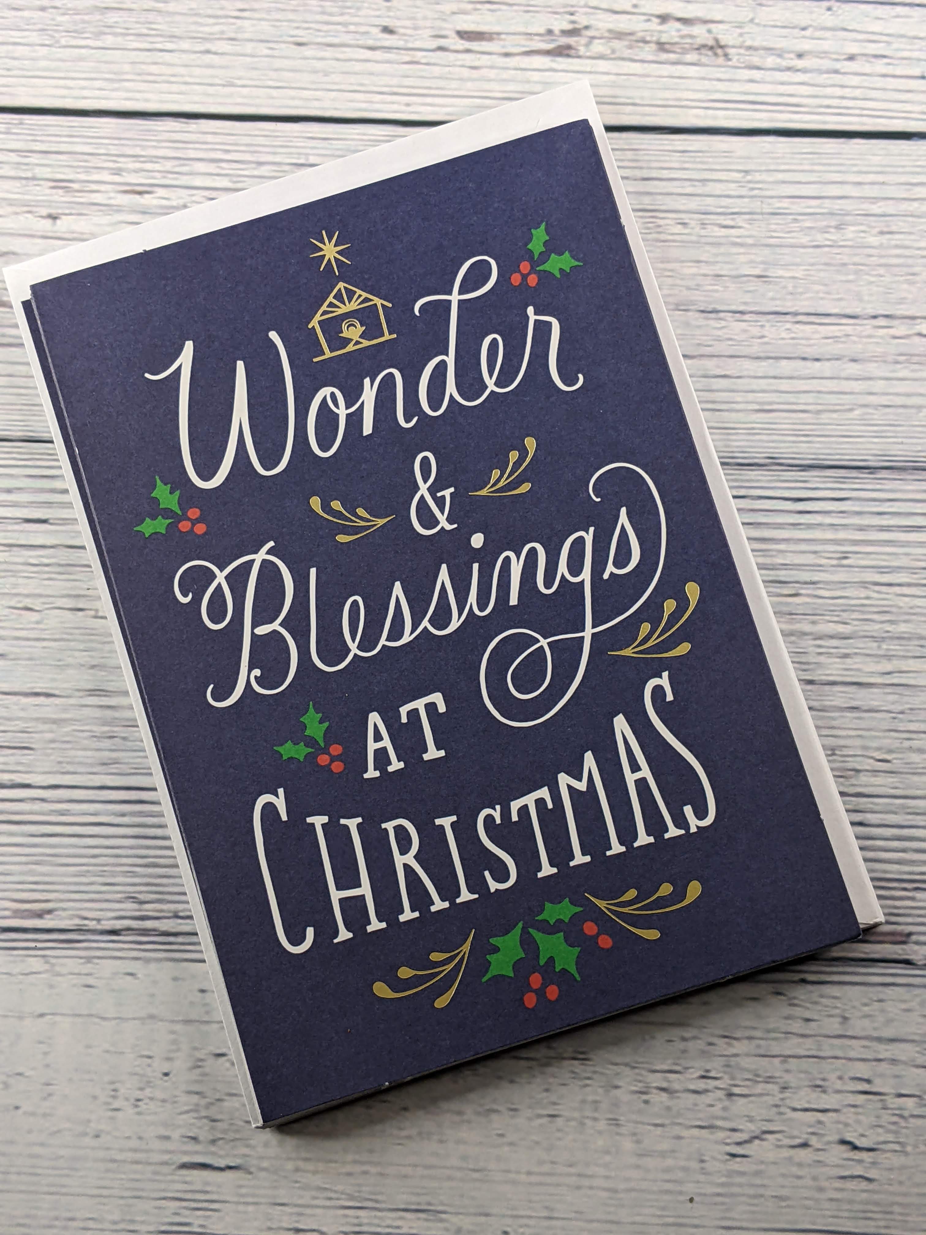 A blue Christmas card with the words "wonder & blessings at Christmas."