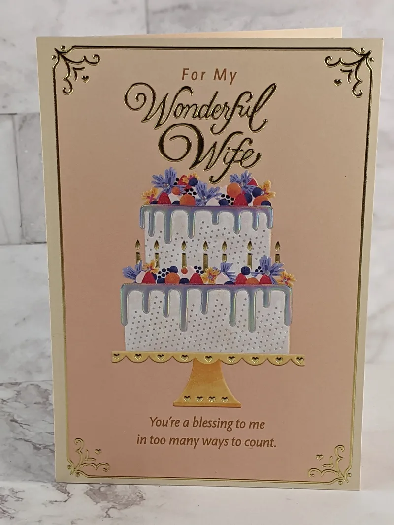 A religious birthday card for a wife with an image of a cake on the front.