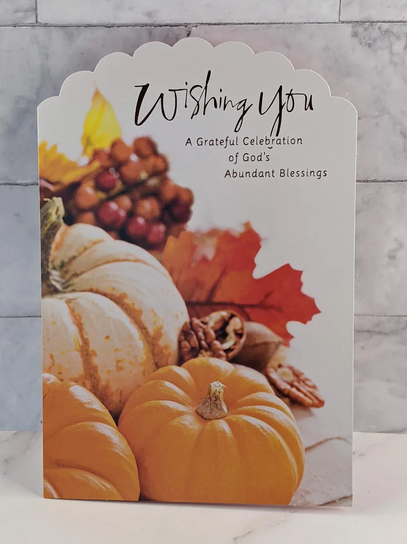 A religious Thanksgiving greeting card with an image of pumpkins on the front.