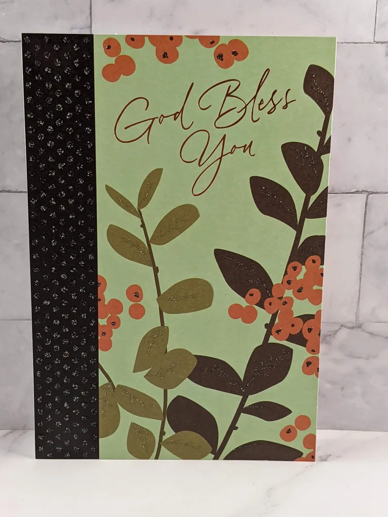 A religious Thanksgiving greeting card with a green cover that has images of leaves and berries.