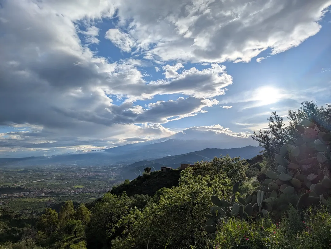 Mount Etna peaking out from beneath the clouds