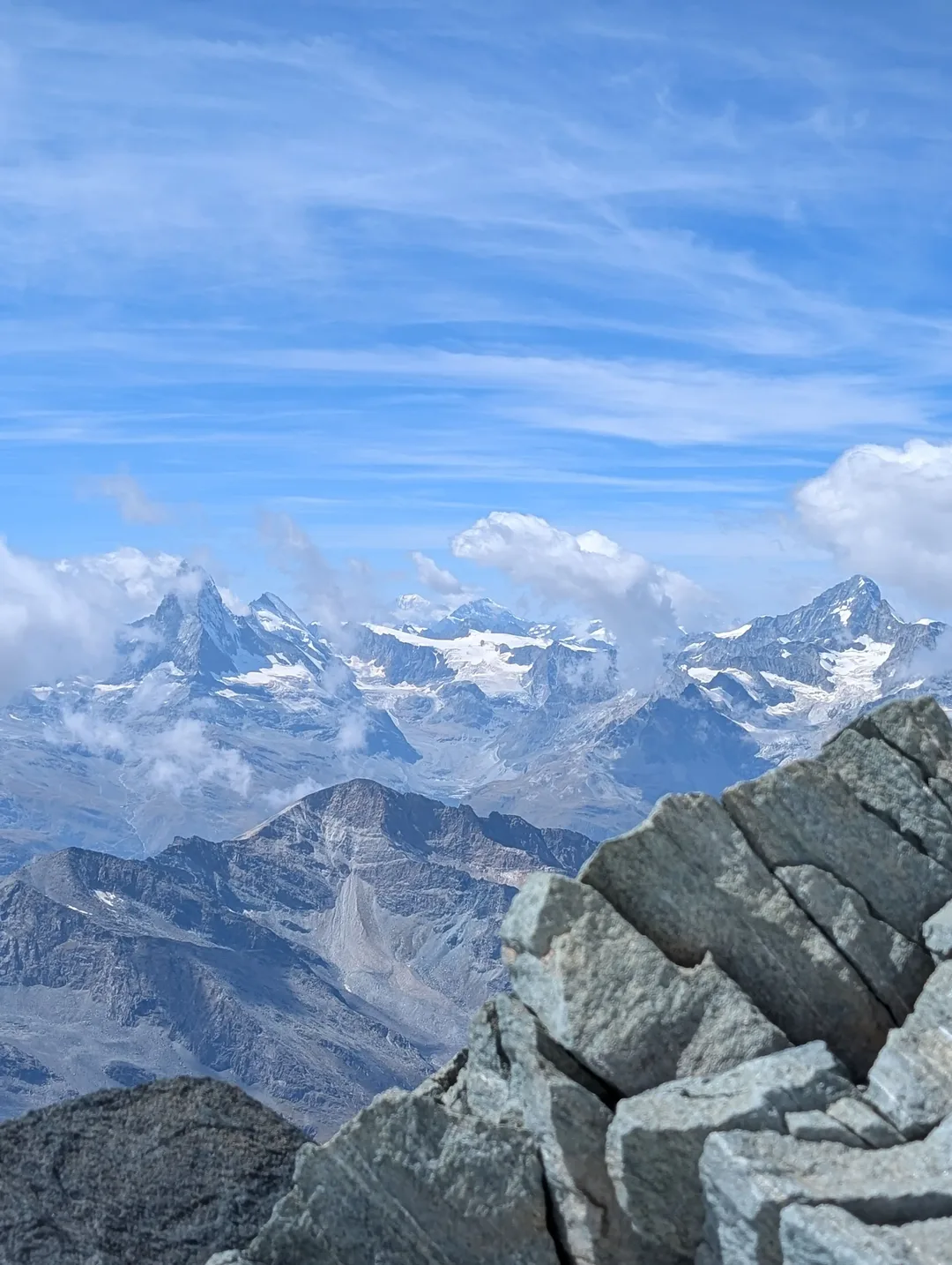 View from the summit with the Matterhorn and Mont Blanc obscured by clouds.