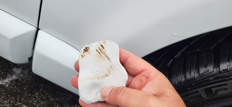Clay Bar treatment being used to remove bonded contamination
