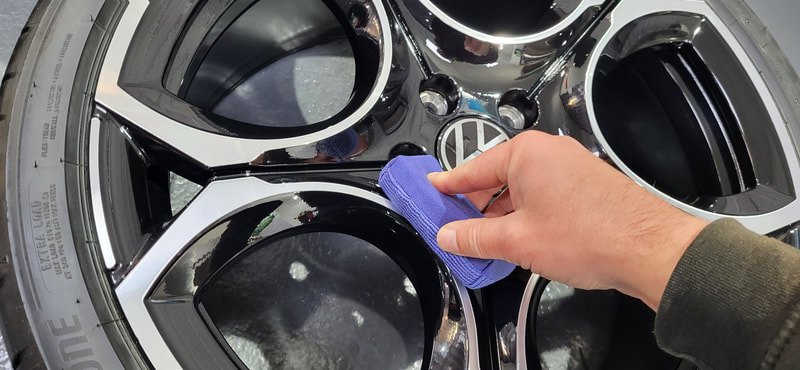 Alloy wheel being ceramic coated at DMD Car Detailing near Erskine