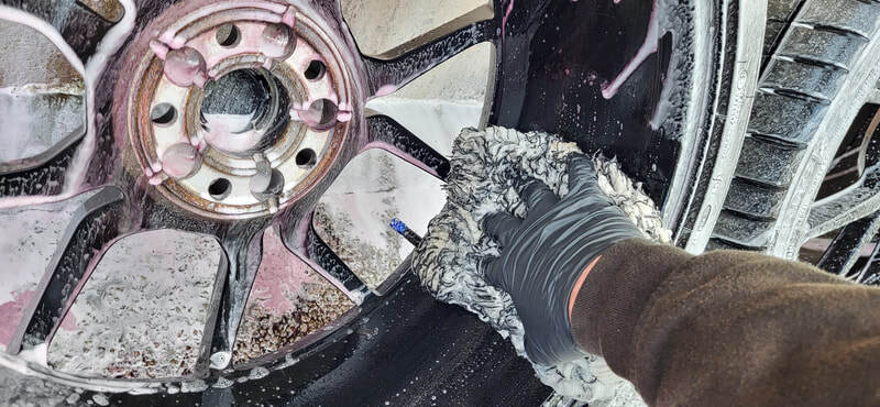 Alloy wheel being cleaned ahead of ceramic coating application