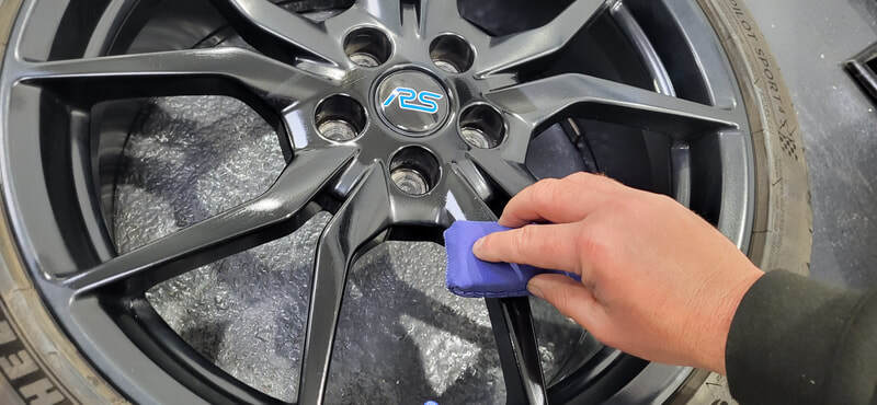 Applying ceramic coating to Focus RS alloy wheel at DMD Car Detailing