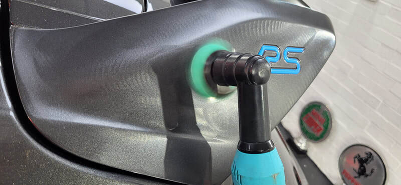 Machine polishing Ford Focus RS spoiler during minor paint correction