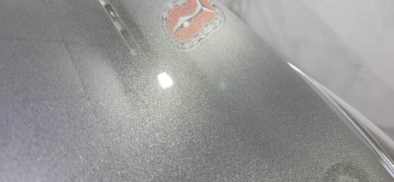 Close-up of corrected paintwork showing improved clarity and gloss