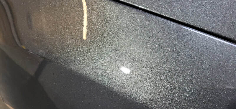 Close-up of Focus RS paintwork reflecting workshop lighting post-coating