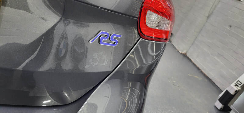 Focus RS badge detail showing surrounding paint clarity