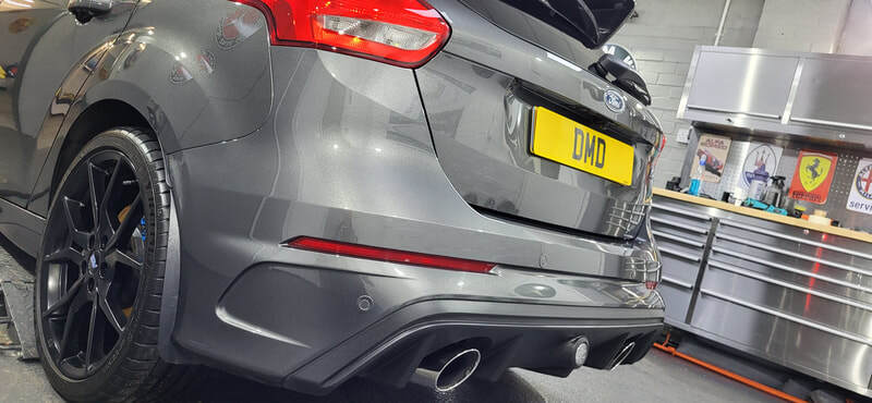 Close-up of rear of the Focus RS paintwork reflecting workshop lighting post-coating
