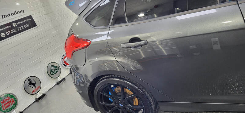 Close-up of Focus RS paintwork reflecting workshop lighting post-coating