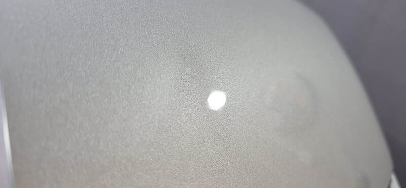 Close-up of KIA EV3 bonnet showing coated gloss finish