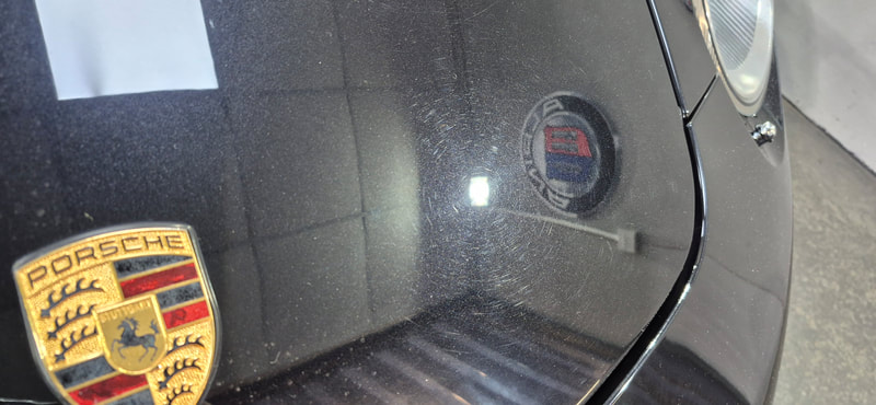 Porsche show swirl marks after poor washing at local car brush wash