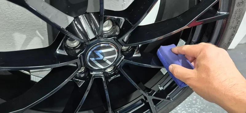 Ceramic coating being applied to a VW Golf GTI alloy wheel at DMD Car Detailing, Paisley