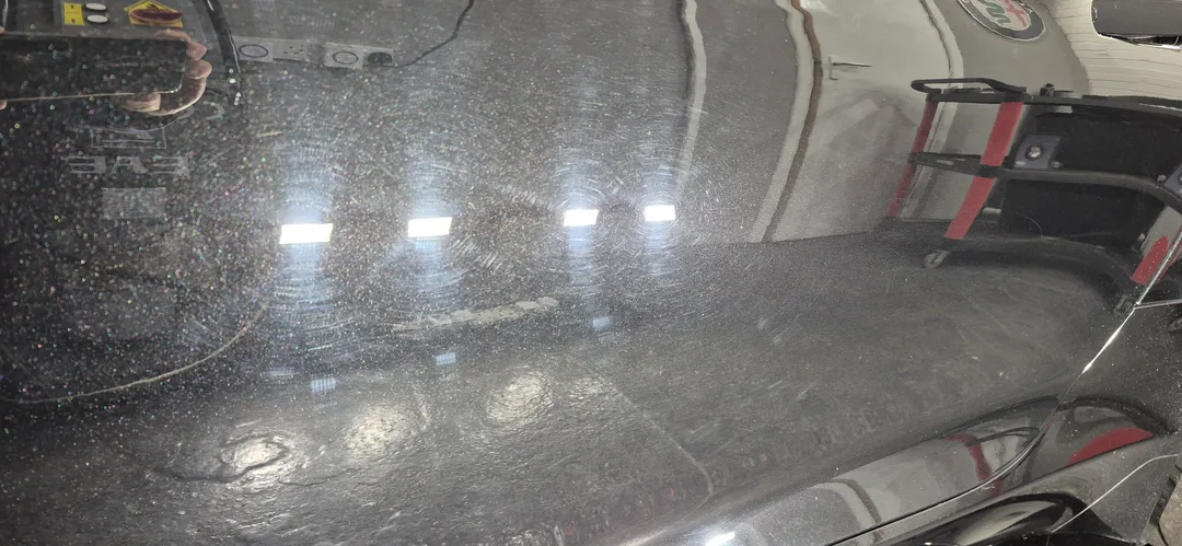 Before photo showing Jaguar F-Type with swirl marks