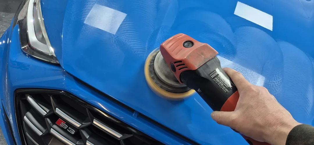 Light machine polish being applied to Turbo blue Audi S3 bonnet