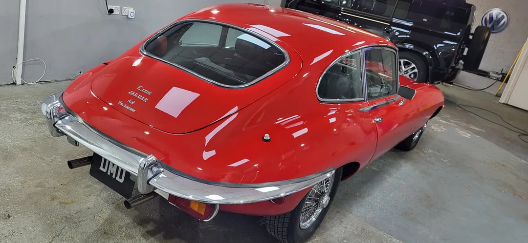 Classic red Jaguar E-Type after paint correction and ceramic coating in Paisley near Glasgow at DMD Car Detailing