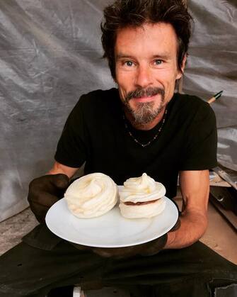 Smiling man with cakes
