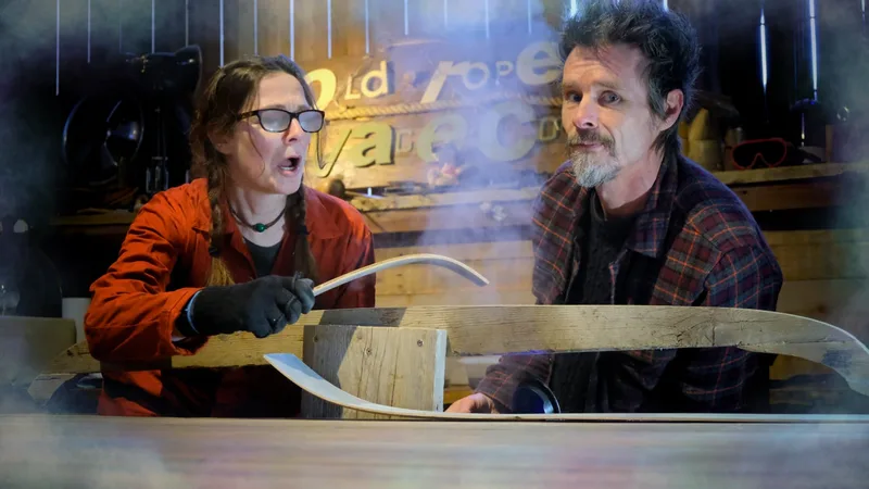 Man and woman steaming and bending a slice of thin oak