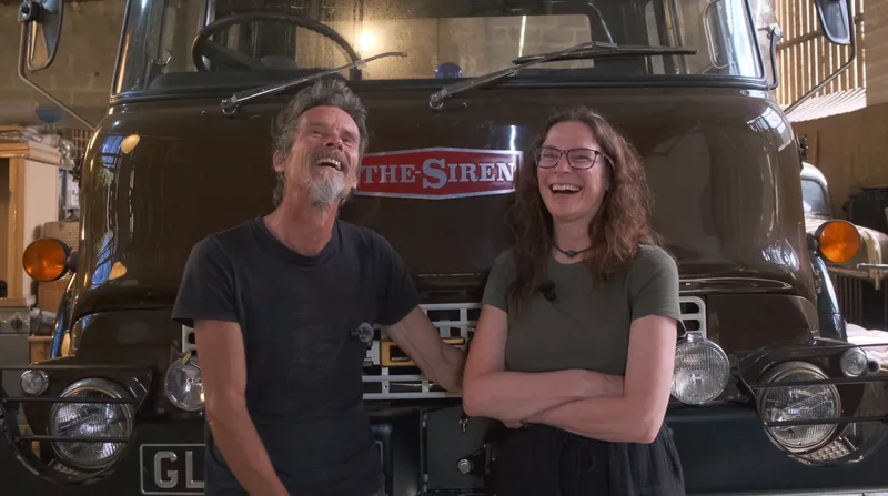 Man and woman standing in front of the Bedford truck named ‘The Siren’