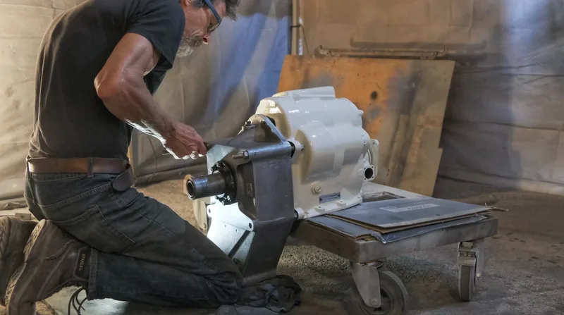 Man restoring the gearbox from a 1970s Bedford truck